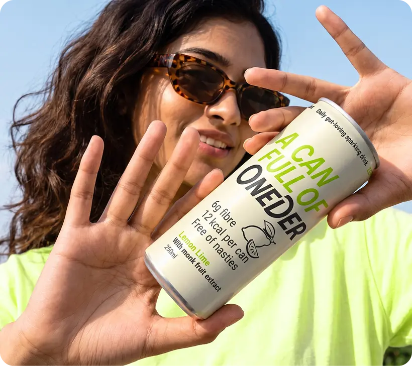 A woman in sunglasses holding a lemon lime Oneder can